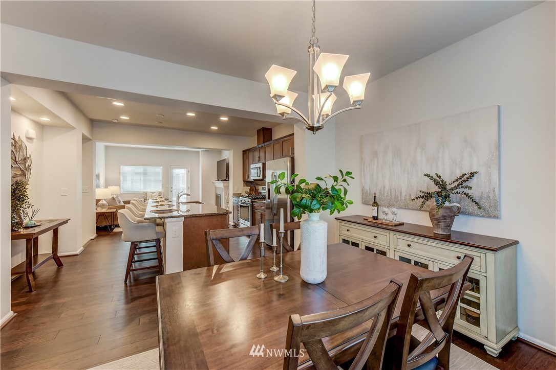 3010 34th Place Everett, WA 98201 - Photo 8 of 39 a view of a dining room and livingroom with furniture wooden floor a chandelier