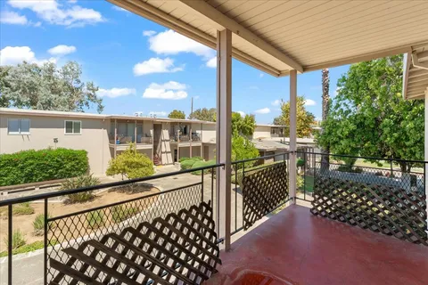a view of a balcony with furniture