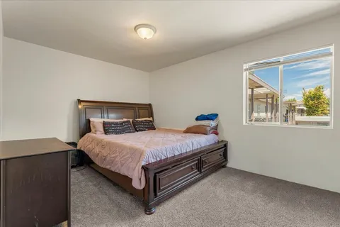 a bedroom with a bed and window