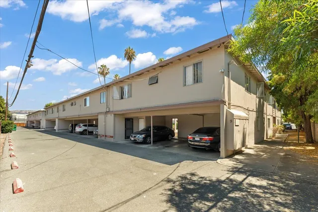 a car parked in front of a white building
