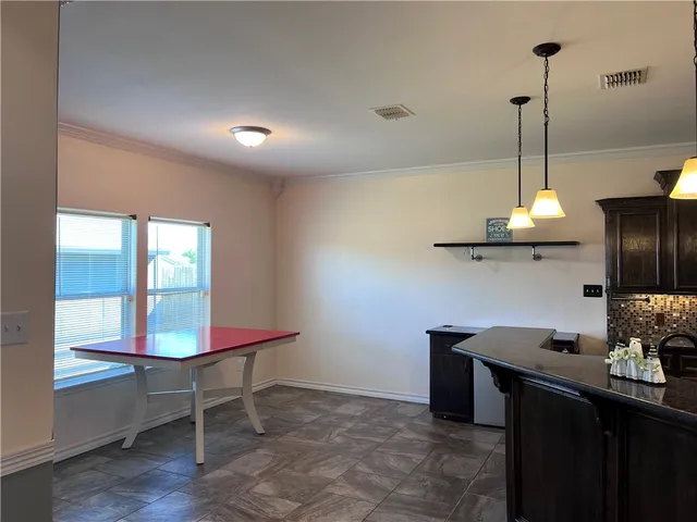 a kitchen with stainless steel appliances granite countertop a sink a stove and a refrigerator