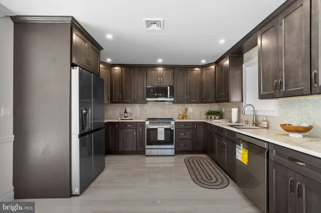 a kitchen with a sink stainless steel appliances and cabinets