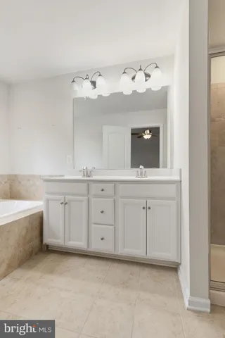 a bathroom with a sink vanity and mirror