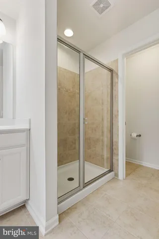 a bathroom with a glass shower door