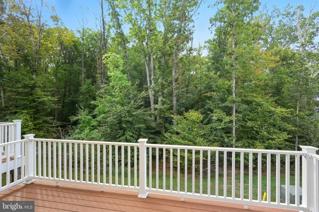 a view of a balcony with wooden floor and fence