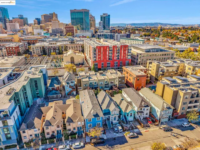 a view of many buildings and cars parked in front of street