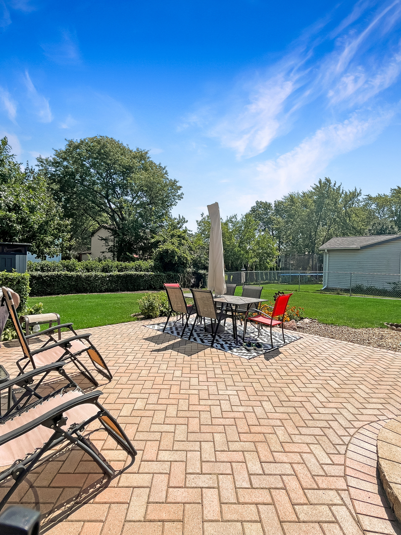 985 Greenridge Road Buffalo Grove, IL 60089 - Photo 17 of 20 a view of swimming pool with seating space and trees in the background