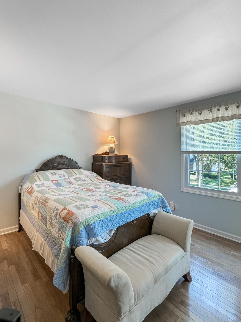 985 Greenridge Road Buffalo Grove, IL 60089 - Photo 10 of 20 a bedroom with a bed and window