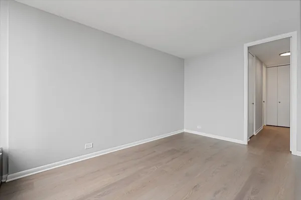 an empty room with wooden floor