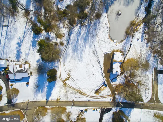 a view of a yard with wooden fence