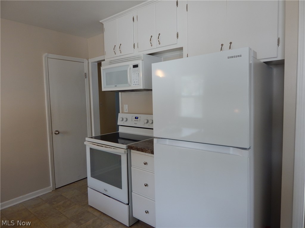 5701 Ackley Road Parma, OH 44129 - Photo 4 of 31 Appliances Stay! Brand new Refrigerator (2019) Stove & Microwave (2017). Pantry is the door in rear.