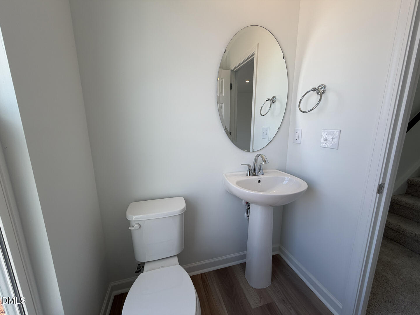 3328 Bomore Road Raleigh, NC 27610 - Photo 22 of 47 a bathroom with a toilet sink and mirror