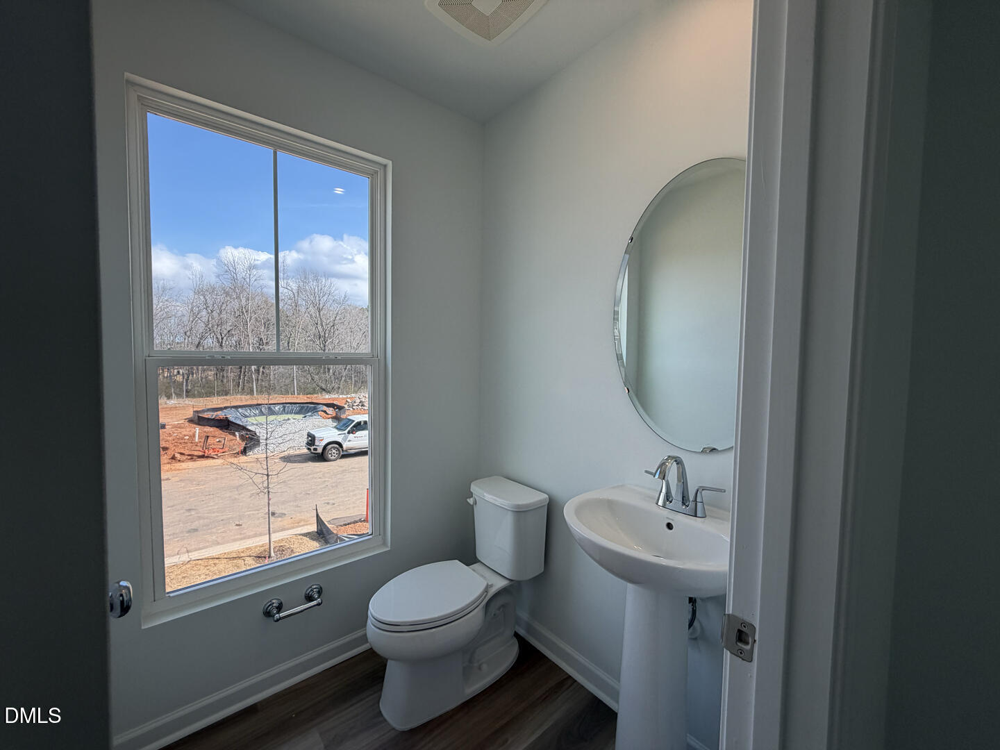 3328 Bomore Road Raleigh, NC 27610 - Photo 23 of 47 a bathroom with a toilet sink vanity and mirror