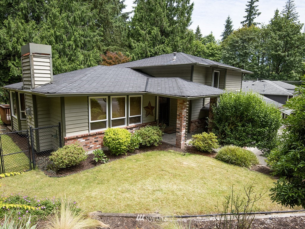 21922 Southeast 255th Place Maple Valley, WA 98038 - Photo 1 of 40 a front view of a house with garden