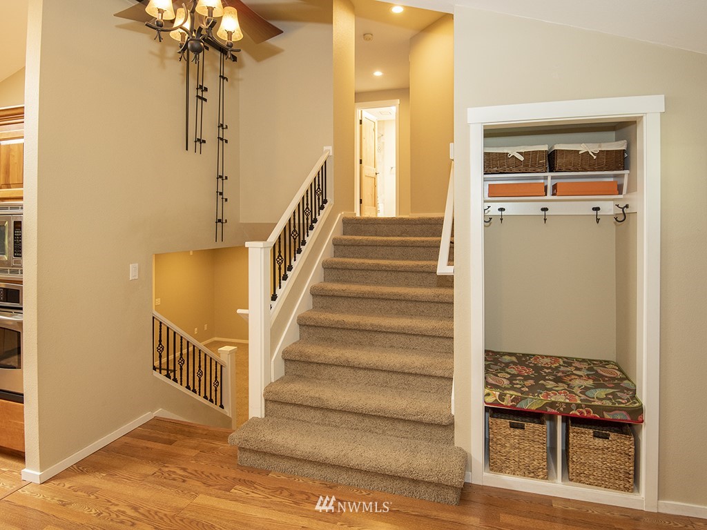 21922 Southeast 255th Place Maple Valley, WA 98038 - Photo 12 of 40 a view of entryway and hall with wooden floor