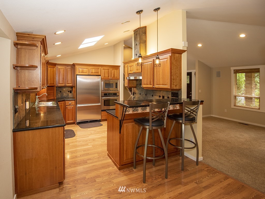21922 Southeast 255th Place Maple Valley, WA 98038 - Photo 5 of 40 a view of a dining room with furniture