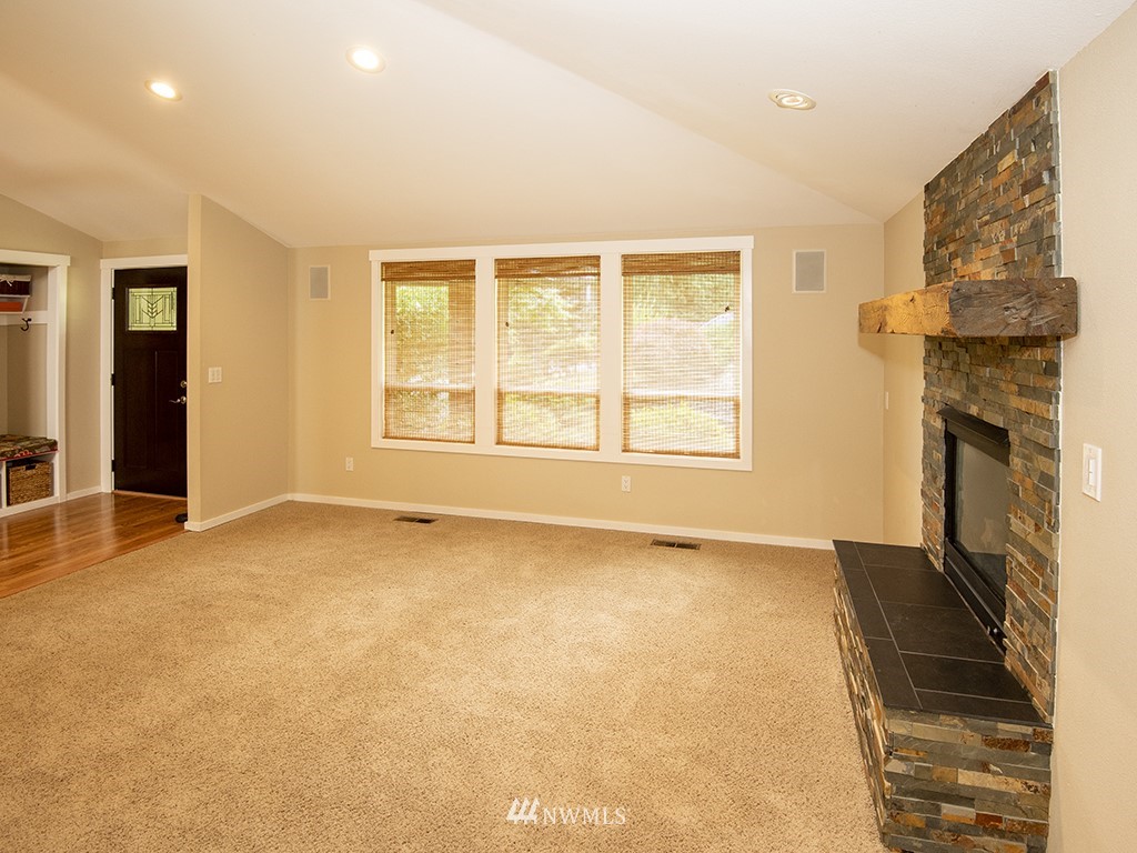 21922 Southeast 255th Place Maple Valley, WA 98038 - Photo 10 of 40 a view of an empty room with a fireplace and a window