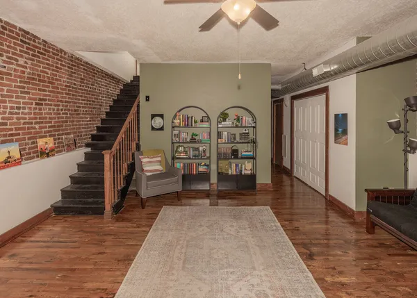 a kitchen with stainless steel appliances a stove refrigerator a sink a microwave oven with cabinets and wooden floor