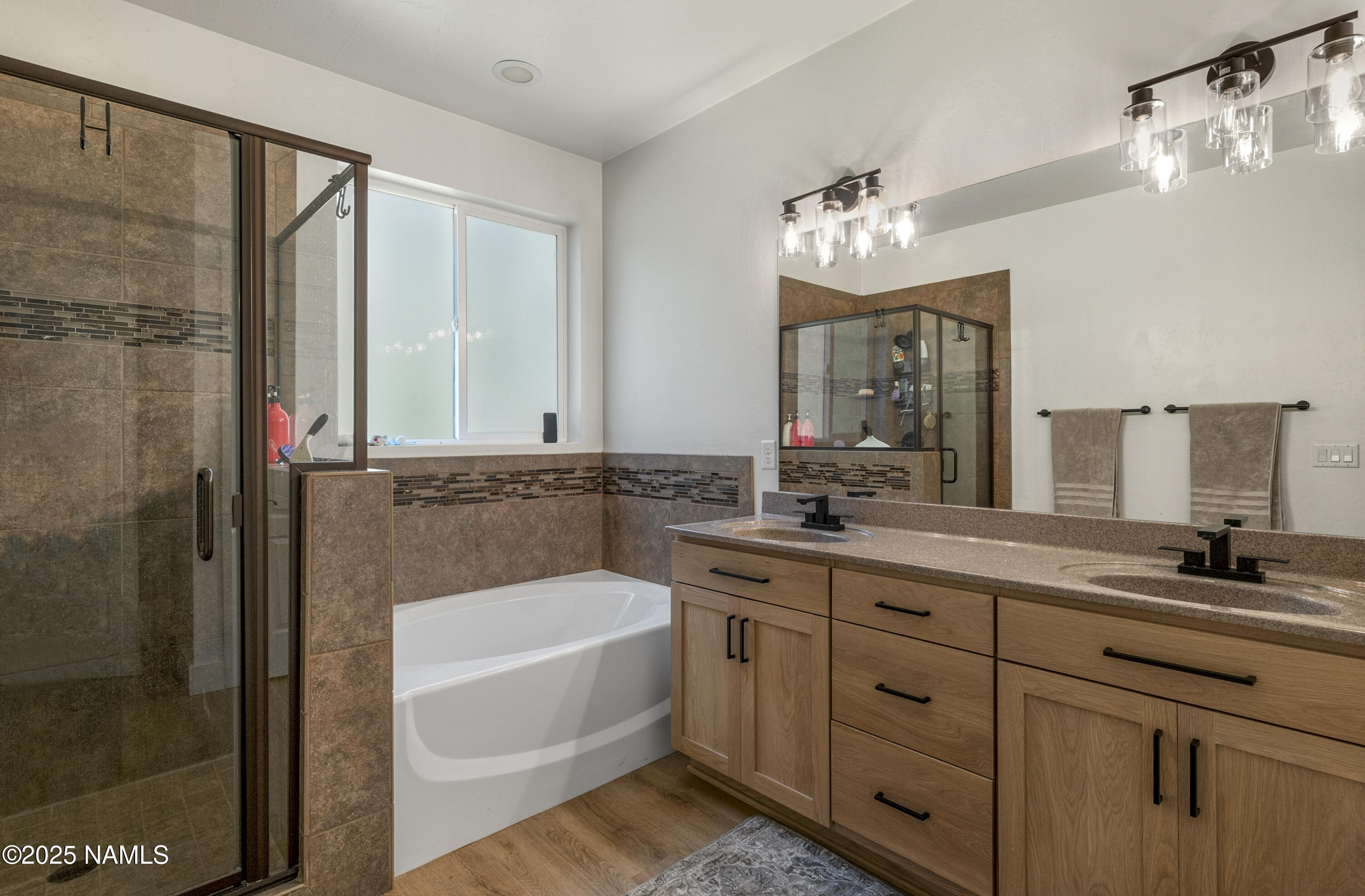 5053 South Topaz Road Flagstaff, AZ 86005 - Photo 11 of 25 a bathroom with a double vanity sink mirror and shower