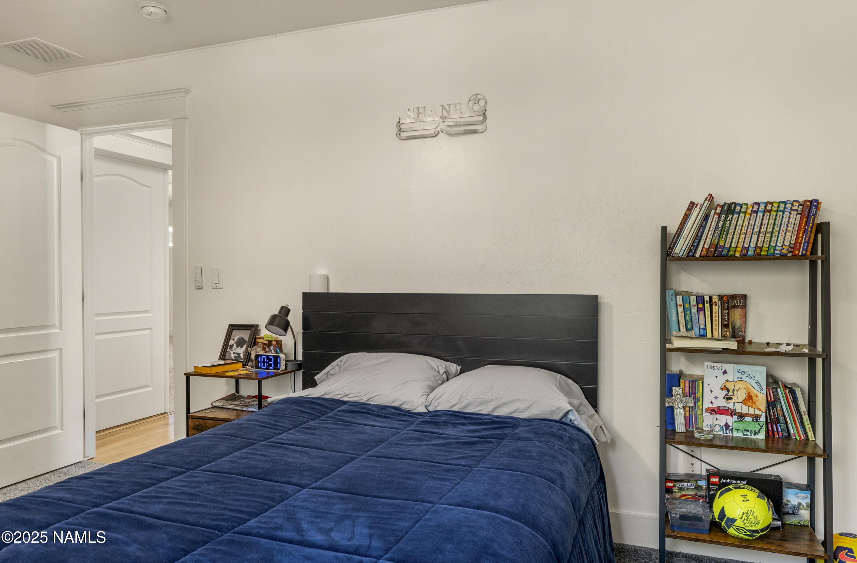 5053 South Topaz Road Flagstaff, AZ 86005 - Photo 16 of 25 a bedroom with a bed and cabinets