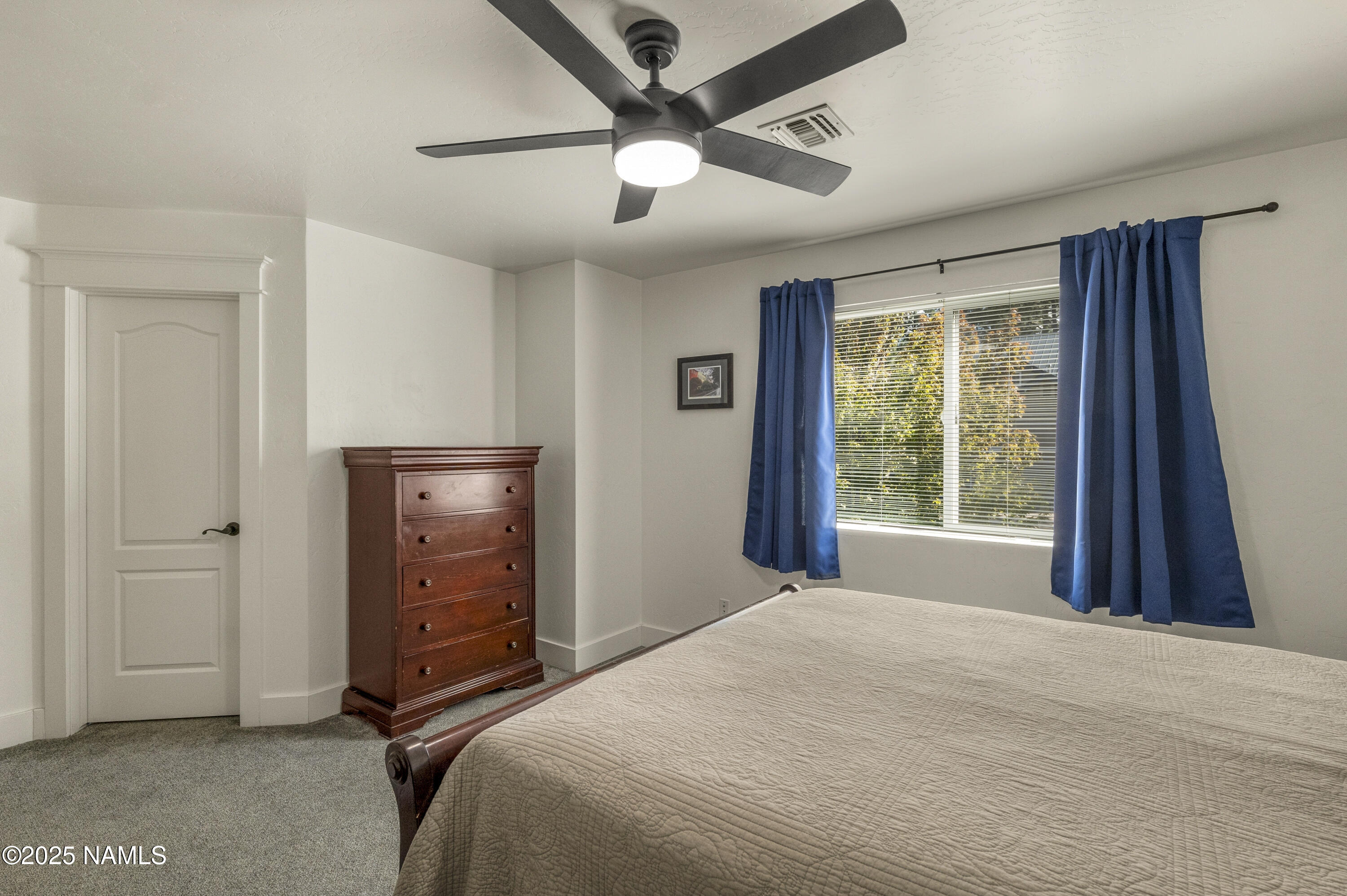 5053 South Topaz Road Flagstaff, AZ 86005 - Photo 18 of 25 a bedroom with a bed and a window