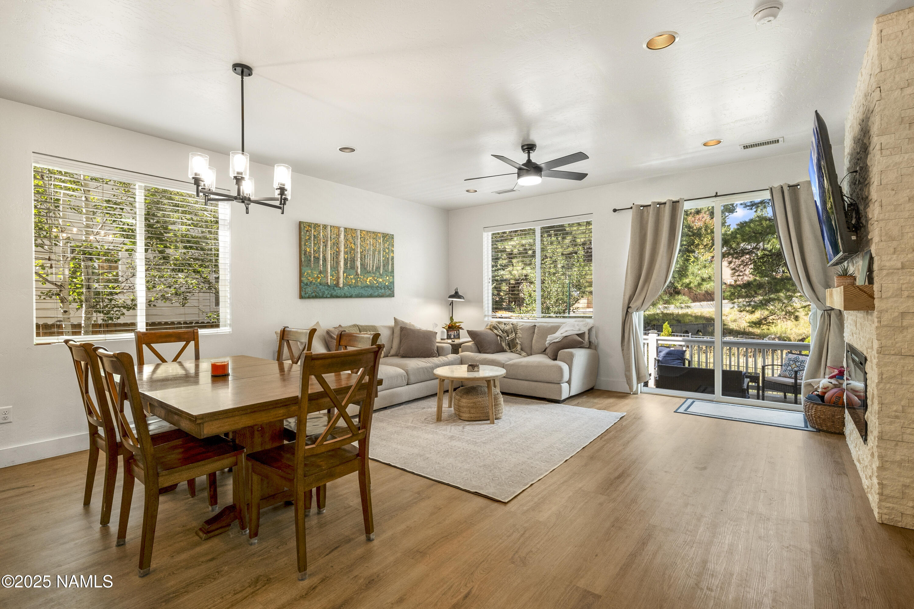 5053 South Topaz Road Flagstaff, AZ 86005 - Photo 6 of 25 a living room with furniture a flat screen tv and a large window