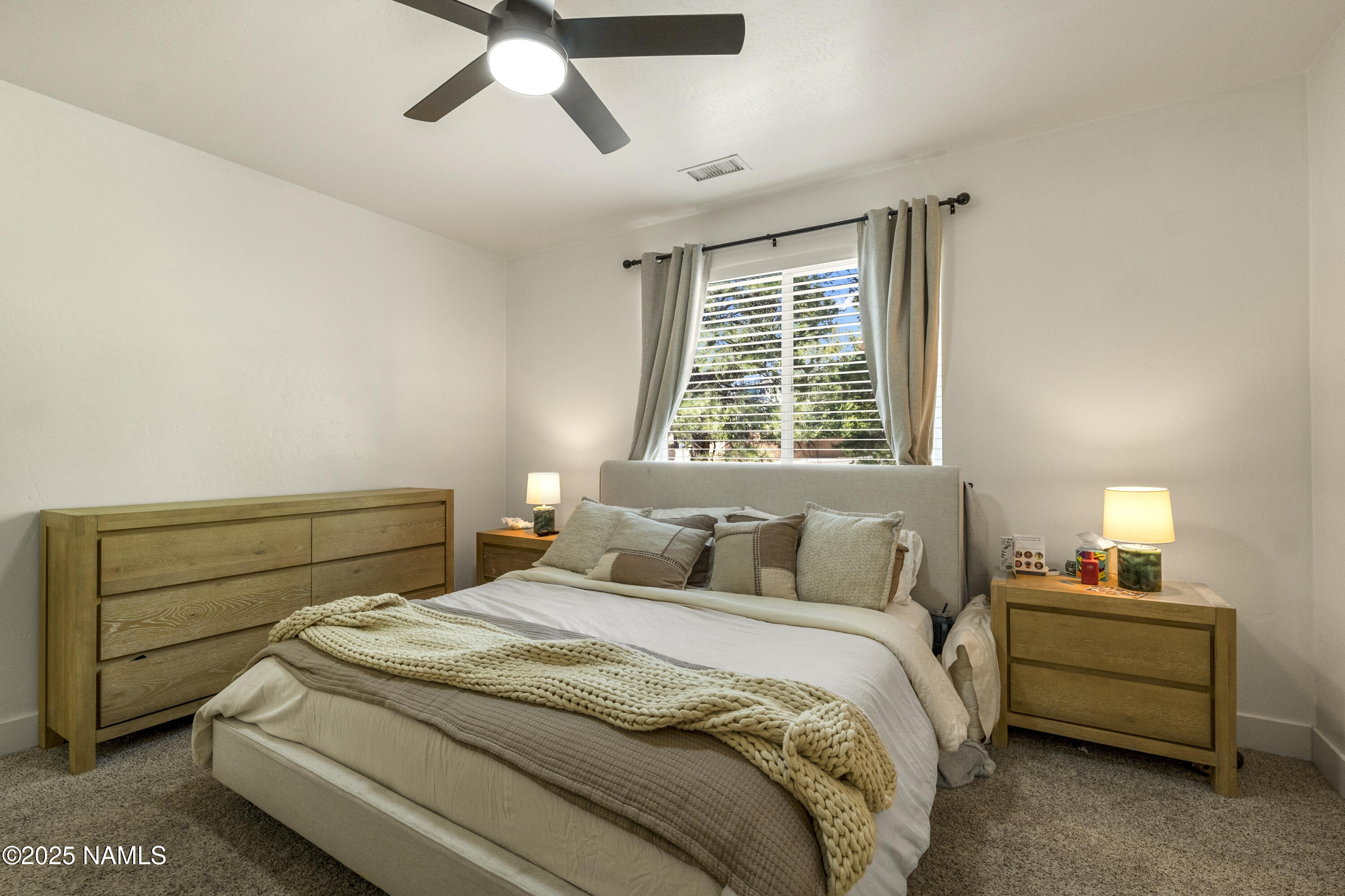 5053 South Topaz Road Flagstaff, AZ 86005 - Photo 9 of 25 a bedroom with a bed and a chandelier