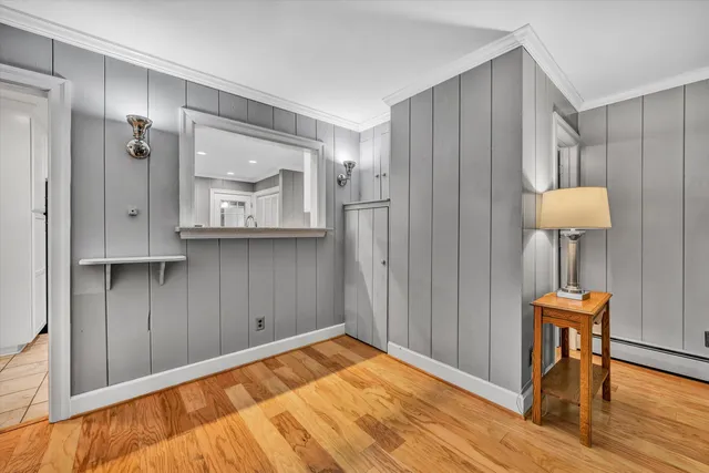 a view of a room that has a bed and a table in it