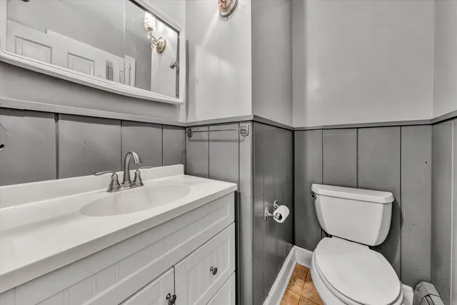 a bathroom with a toilet a sink and a mirror