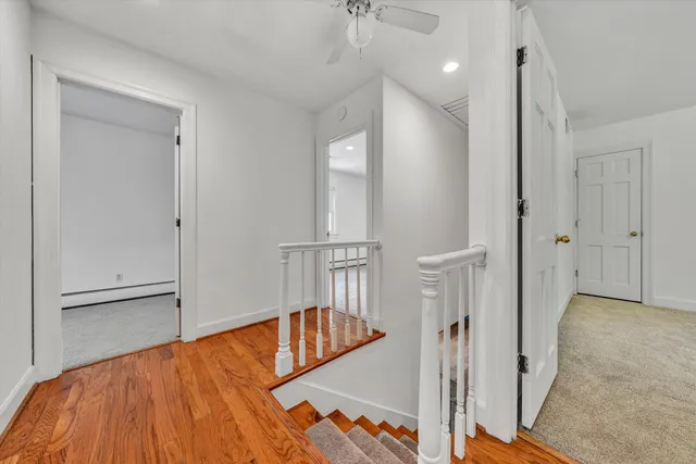 a very nice looking room with wooden floor and a carpet