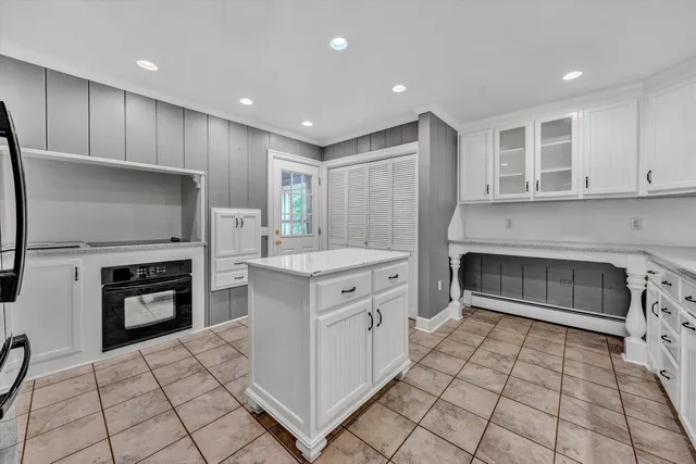 a kitchen with granite countertop a stove a sink and a microwave