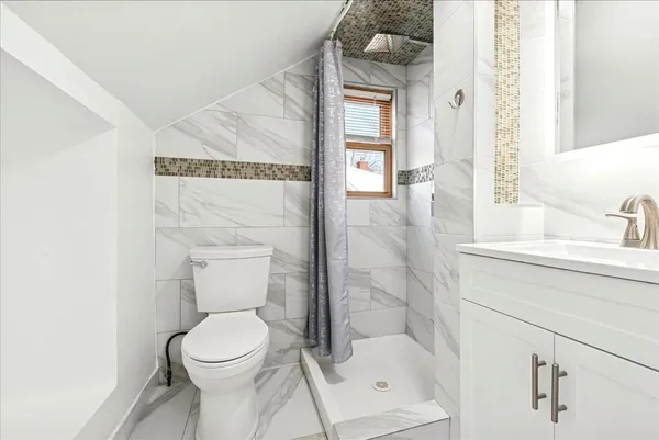 a bathroom with a toilet sink and shower