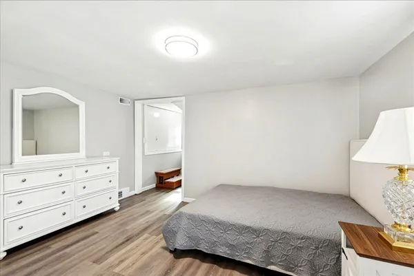 a bedroom with a bed and a dresser in it