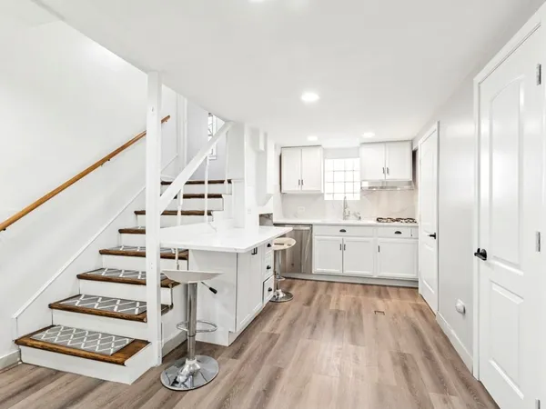 a view of kitchen with sink and wooden floor