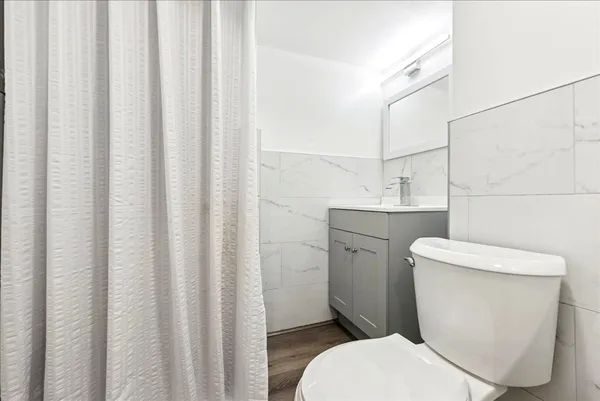 a white toilet sitting next to a small sink