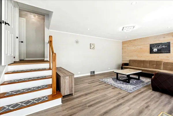 a living room with a table and a potted plant