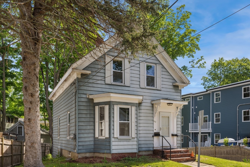 40 Village Street Reading, MA 01867 - Photo 1 of 36 a front view of a house with a yard