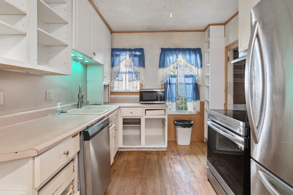 40 Village Street Reading, MA 01867 - Photo 11 of 36 a kitchen with a sink stove and refrigerator