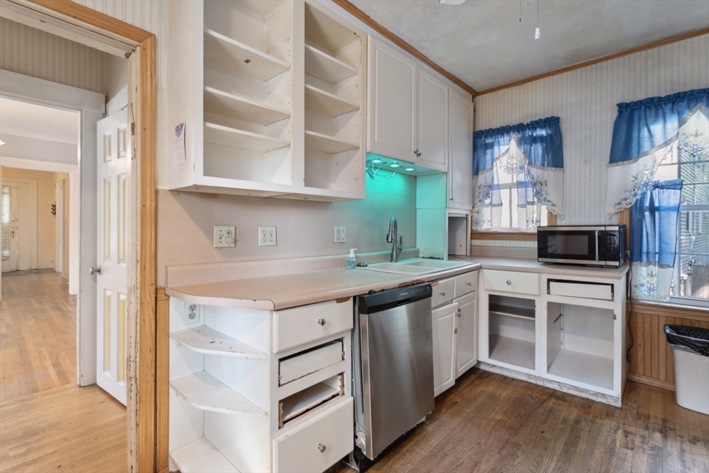 40 Village Street Reading, MA 01867 - Photo 12 of 36 a kitchen with stainless steel appliances granite countertop a stove and a sink