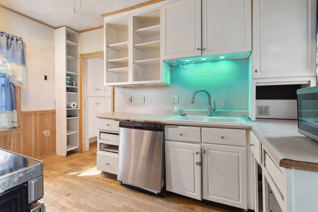 40 Village Street Reading, MA 01867 - Photo 14 of 36 a kitchen with granite countertop a sink and a stove