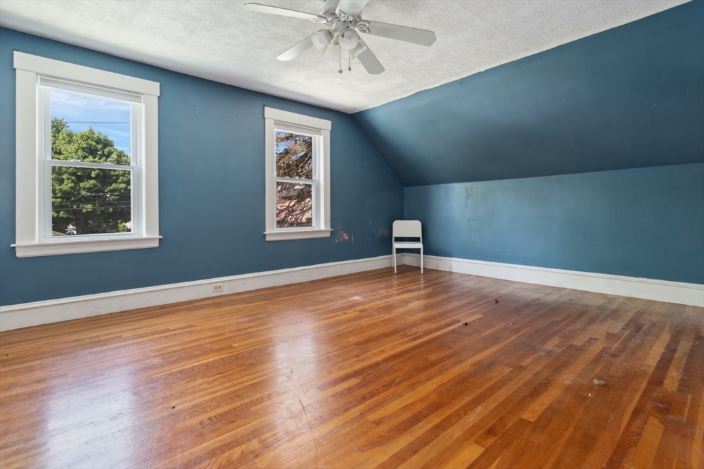 40 Village Street Reading, MA 01867 - Photo 18 of 36 a view of an empty room with wooden floor and a window