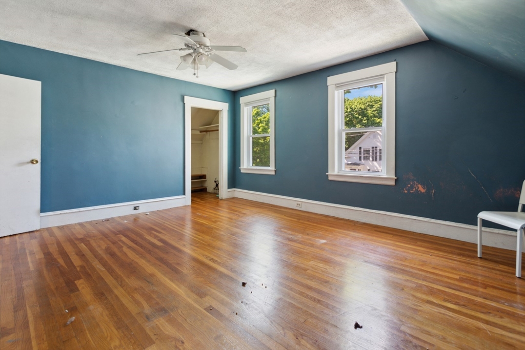 40 Village Street Reading, MA 01867 - Photo 20 of 36 a view of an empty room with wooden floor and a window