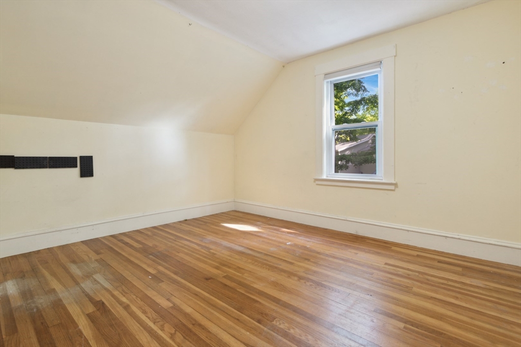 40 Village Street Reading, MA 01867 - Photo 21 of 36 an empty room with wooden floor and windows