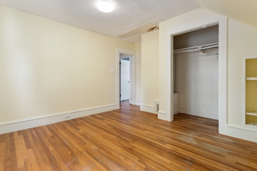 40 Village Street Reading, MA 01867 - Photo 23 of 36 a view of an empty room with wooden floor and a window