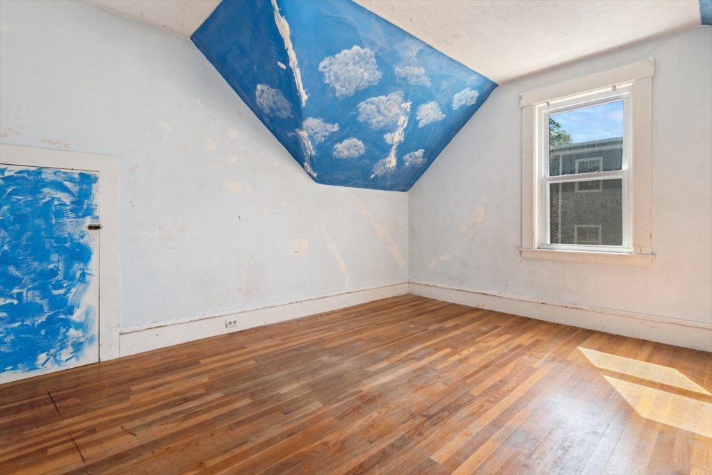 40 Village Street Reading, MA 01867 - Photo 24 of 36 a view of an empty room with wooden floor and a window