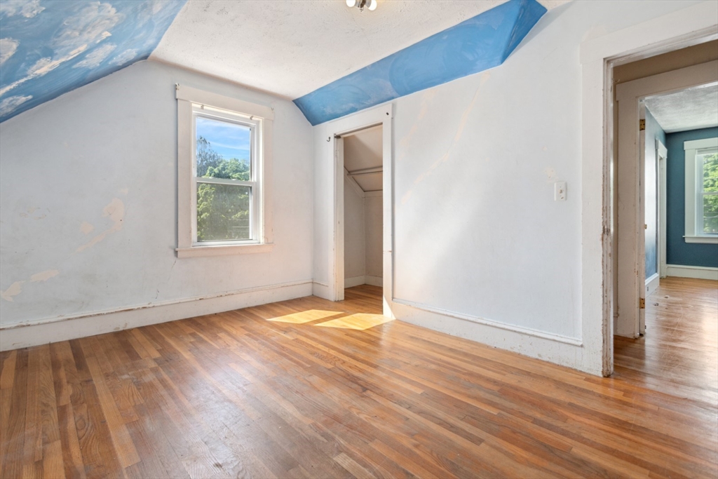 40 Village Street Reading, MA 01867 - Photo 25 of 36 an empty room with wooden floor and windows