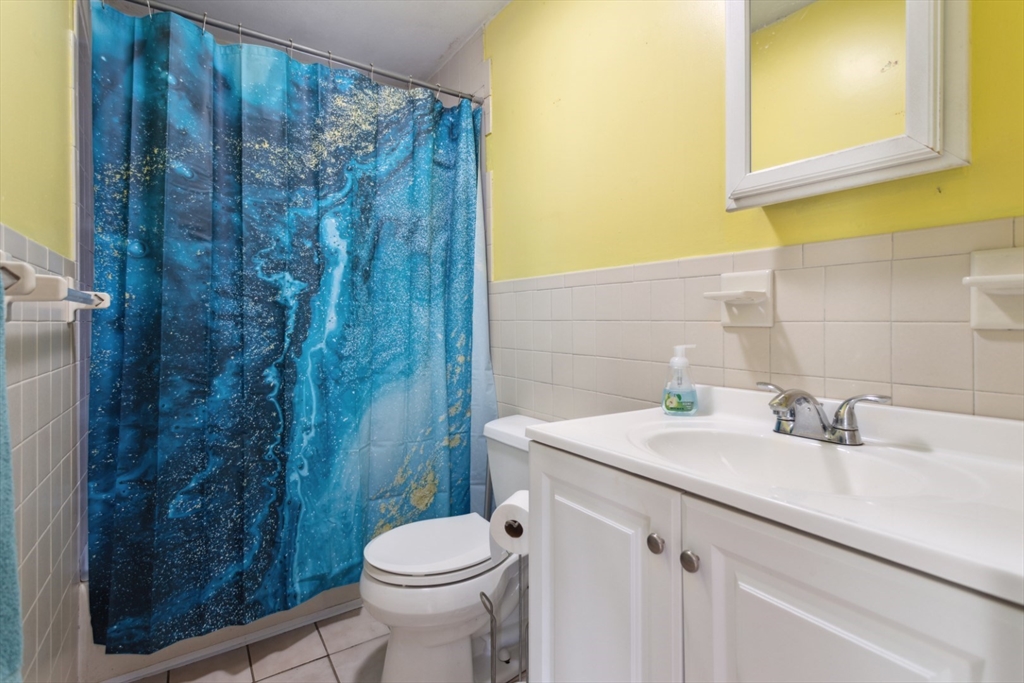 40 Village Street Reading, MA 01867 - Photo 26 of 36 a bathroom with a sink a toilet and shower