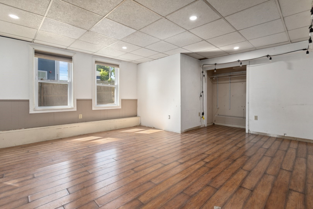 40 Village Street Reading, MA 01867 - Photo 28 of 36 a view of empty room with wooden floor and fan