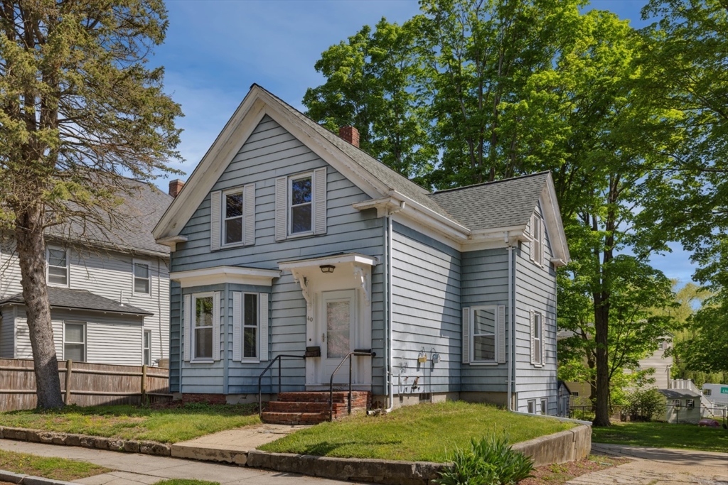 40 Village Street Reading, MA 01867 - Photo 3 of 36 a front view of a house with a yard