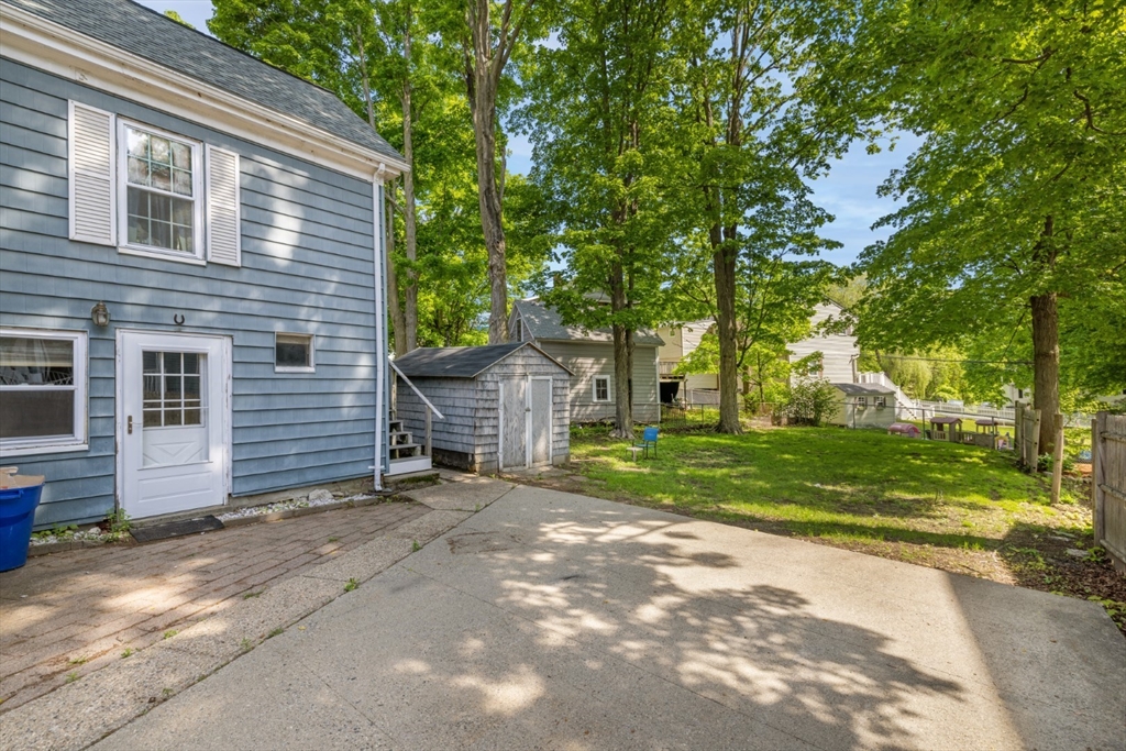 40 Village Street Reading, MA 01867 - Photo 34 of 36 a view of a house with a yard and large tree